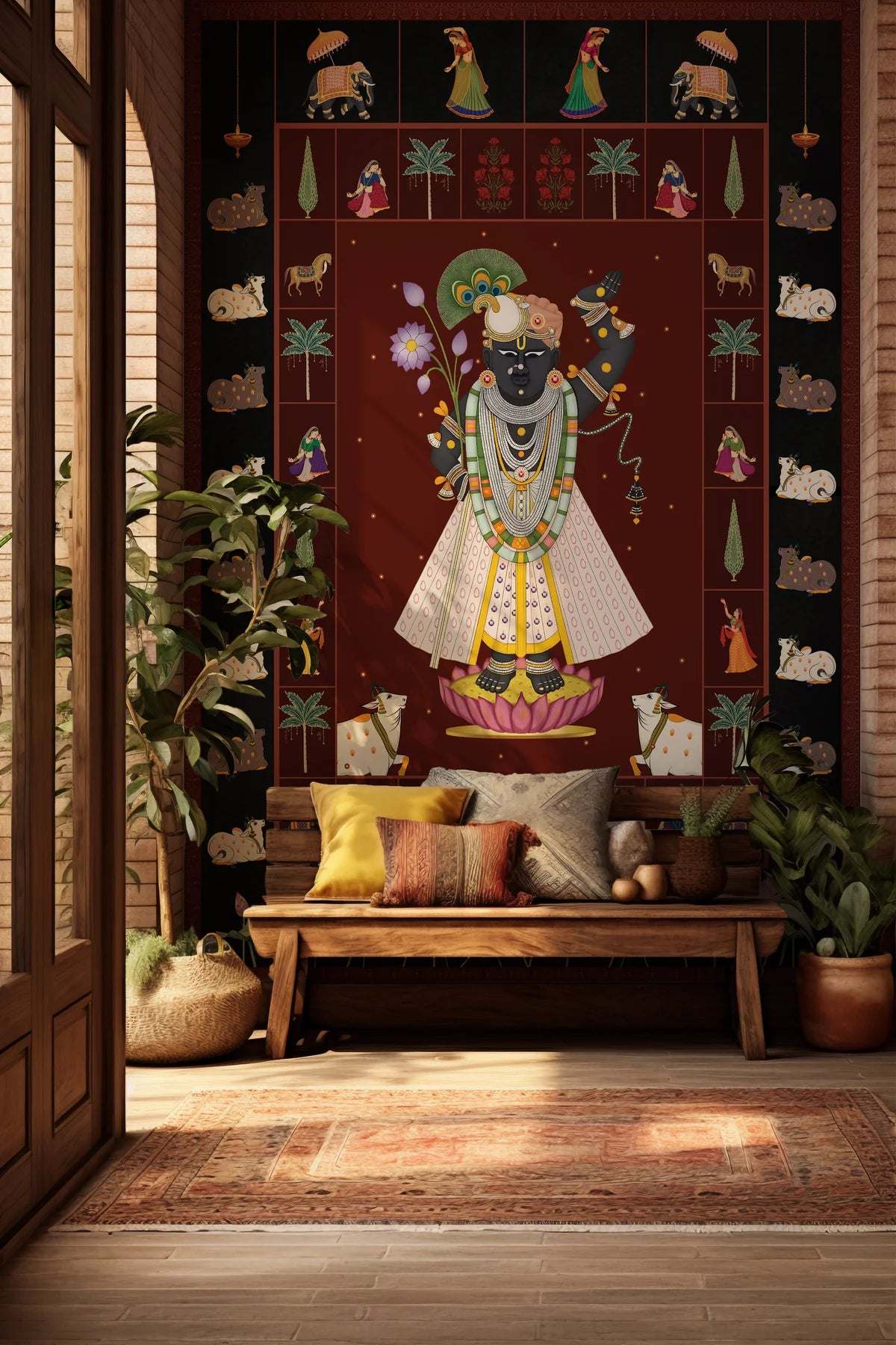 Decorative wall hanging with a central figure in a room with a wooden bench and plants.