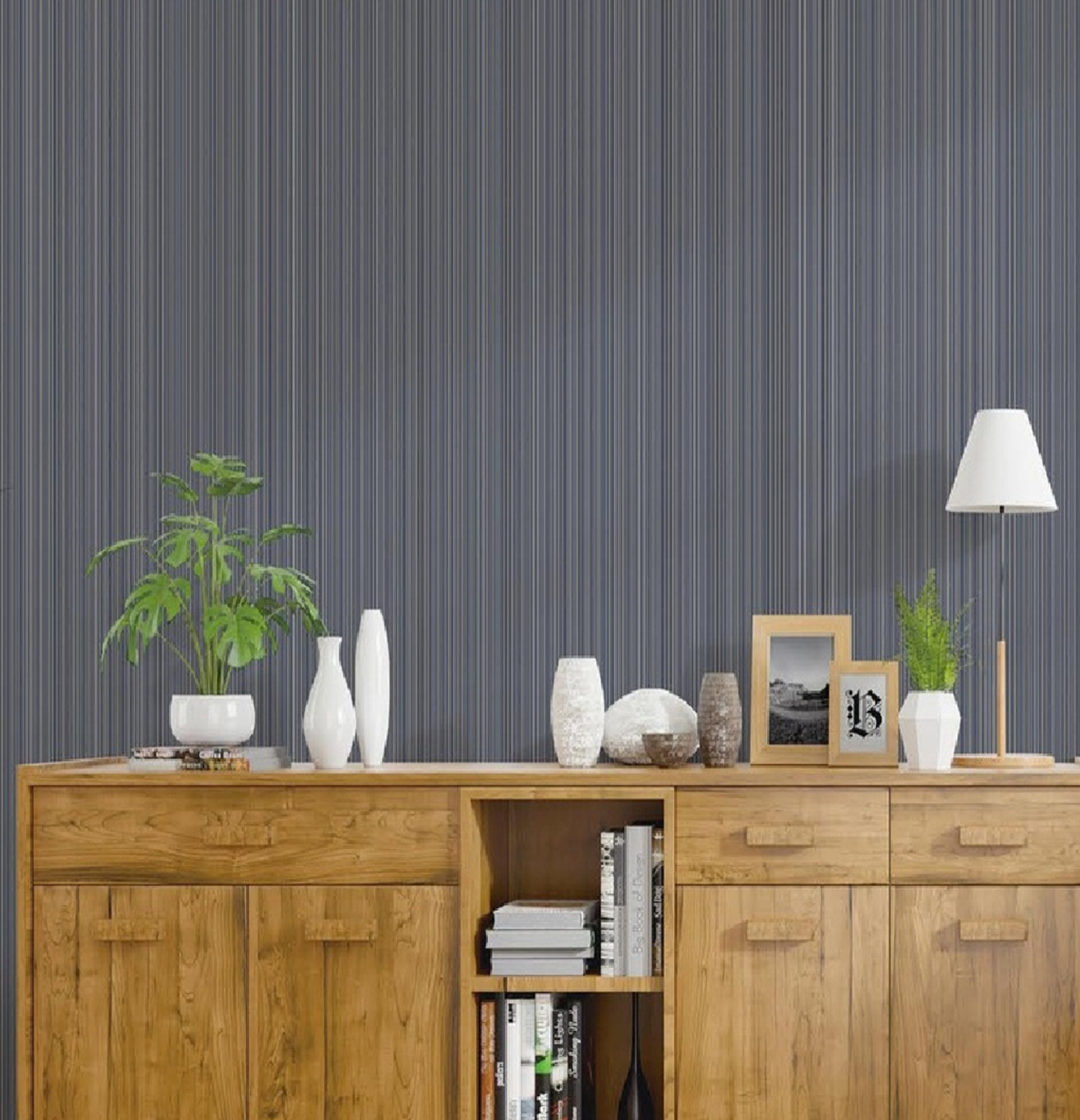 Wooden sideboard with decorative items against a striped wall.