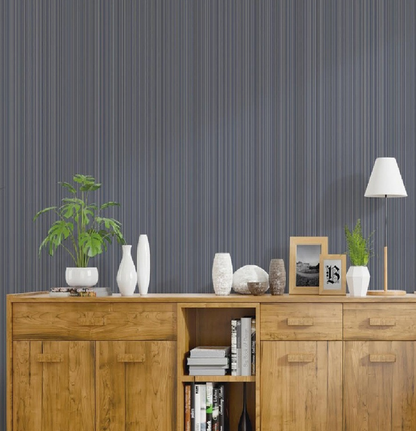 Wooden sideboard with decorative items against a striped wall.